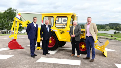 Shown with the restored 1964 JCB 1 backhoe (from left to right): George Bamford, Sir Anthony Bamford, Roland Carnaby Sr. and Roland Carnaby Jr.