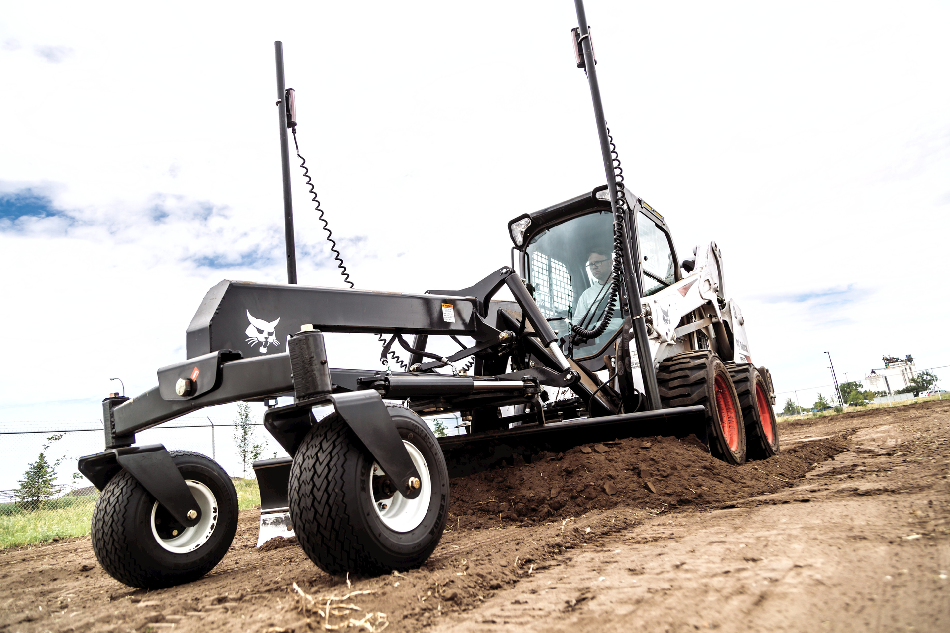 The the grader attachment has a blade that moves six or eight different ways to grade any surface. The bolster oscillates to minimize the effect of uneven ground, delivering consistent grading performance in a variety of environments.