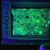 Figure 2. Photograph of a fluorescent thin section in UV light, which makes the concrete glow.