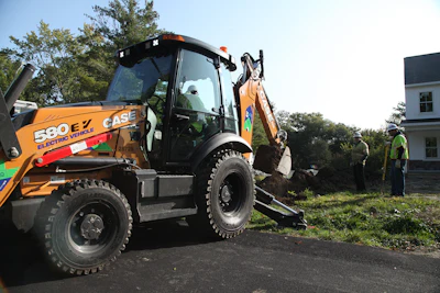 National Grid crews work with the CASE 580 EV backhoe-loader.