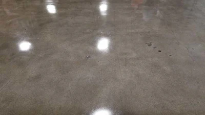 The concrete pictured here is a 1,500 grit polished finish densified with lithium silicate. Once the densifier was dry the coating was sprayed over the surface just enough to ‘wet out’ the surface. The surface was dry to touch in 4 hours and forklift ready in 12 hours the next day.