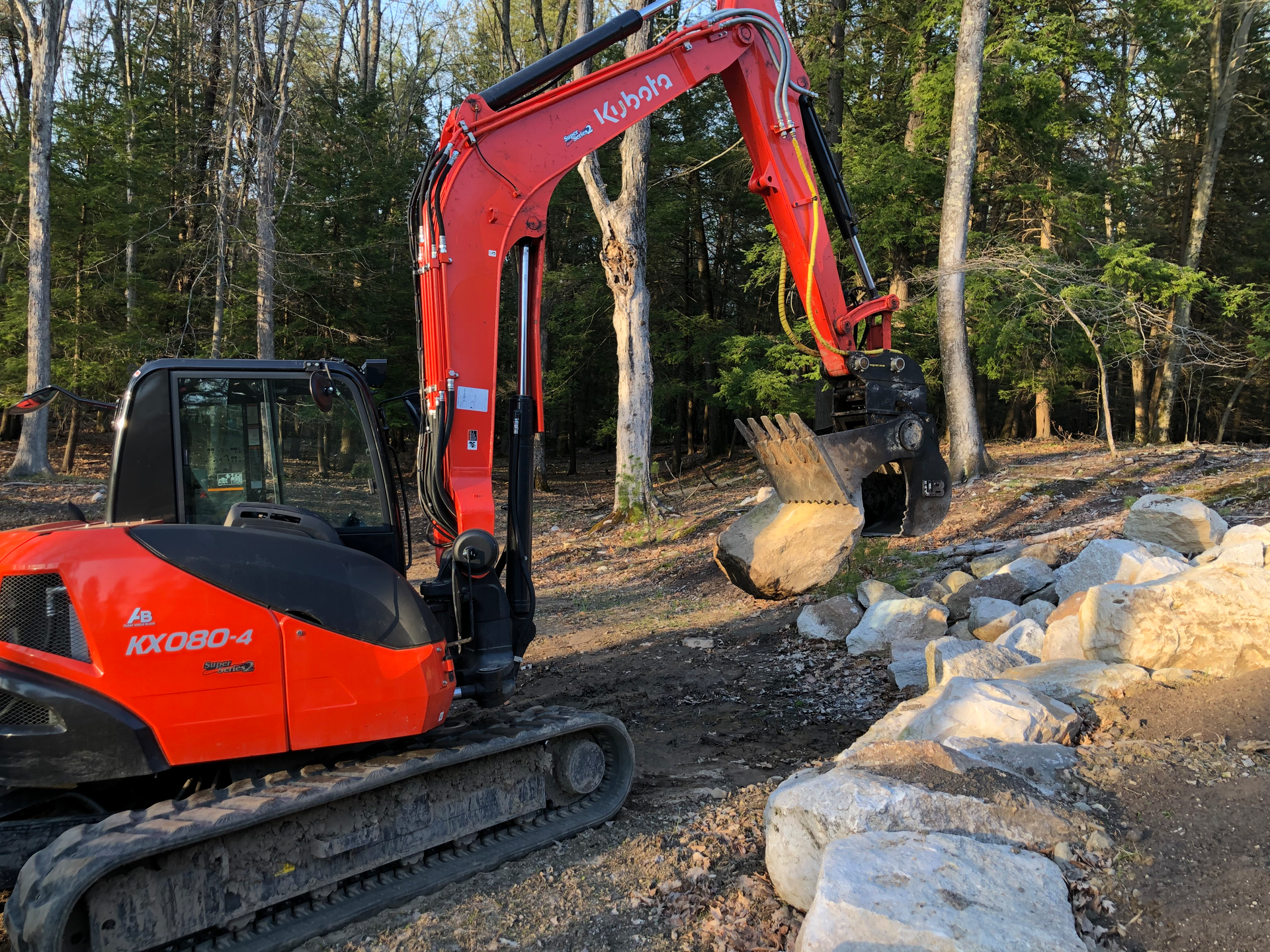 Marlboro Mountain Construction is uses a Werk-Brau Power Grip Bucket and Engcon Tiltrotator to easily grip and move rock and other materials.