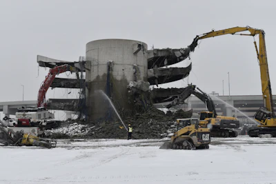 The post-tensioned, four-story parking garage, built in 1990, with concrete reaching 20,000 psi was an impressive demolition challenge.