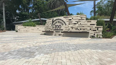 To create the pattern and control water runoff at the same time, Singer Studio chose Eco-Holland permeable pavers in Napoli and Aragon colors from Belgard.