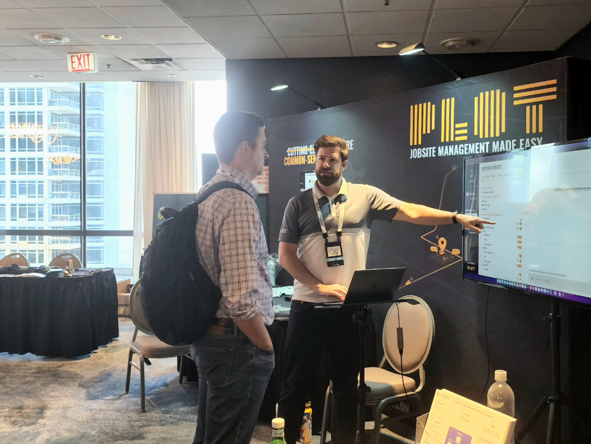 Jobsite logistics startup Plot exhibits at Advancing Construction Technology 2022. Here, Founder and CEO Chris Callen connects with an attendee.