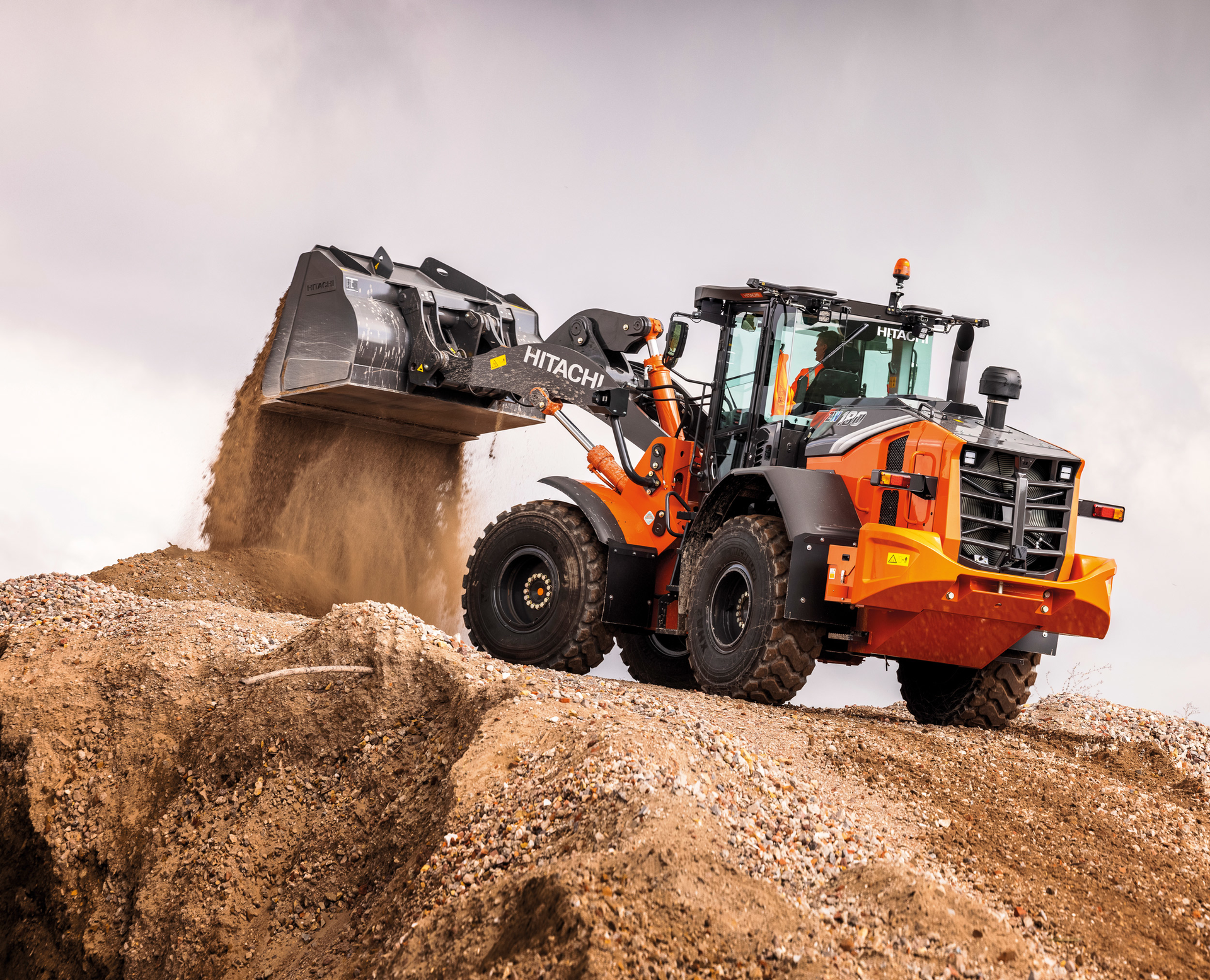 The ZX-7 generation wheel loaders feature a power up mode that increases hill-climbing performance and a large cab with panoramic visibility.