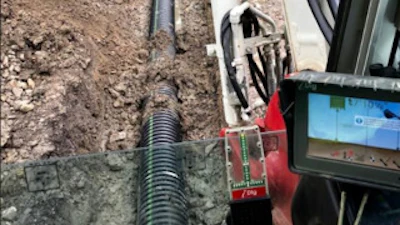iDig's cab-mounted touchscreen display shows the operator the machine's bucket in relation to surrounding surfaces. A light bar with red, orange and green LEDs indicates when the bucket teeth are on grade.