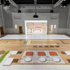 The company utilizes a multifaceted projection approach, displaying building plans on the floor as well as the adjacent wall, providing elevation readings such as countertops, windows and built-in bookshelf heights.