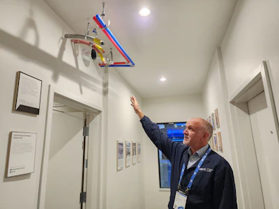 Factory OS Vice President of Design Engineering Andrew Meagher in a residential module with enclosed, inspected panels ready for mechanical installation in the field.