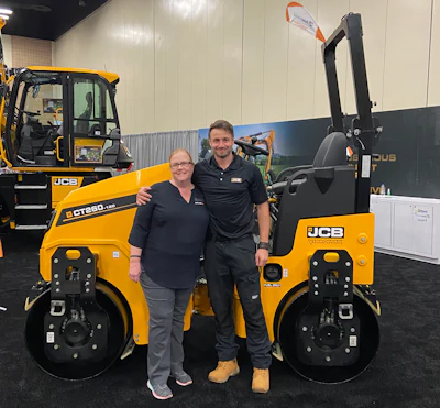 Lori Ditoro, Editor-in-Chief Equipment Today and James Gill, Product Manager, JCB, standing in front of the new CT260 on the PAVE/X showroom floor.