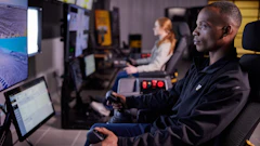 Remote control is also used when performing grading operations under Stage 3 conditions. In this instance, the operator is not on board the vehicle but operating it from a separate location using a joystick or belly box.
