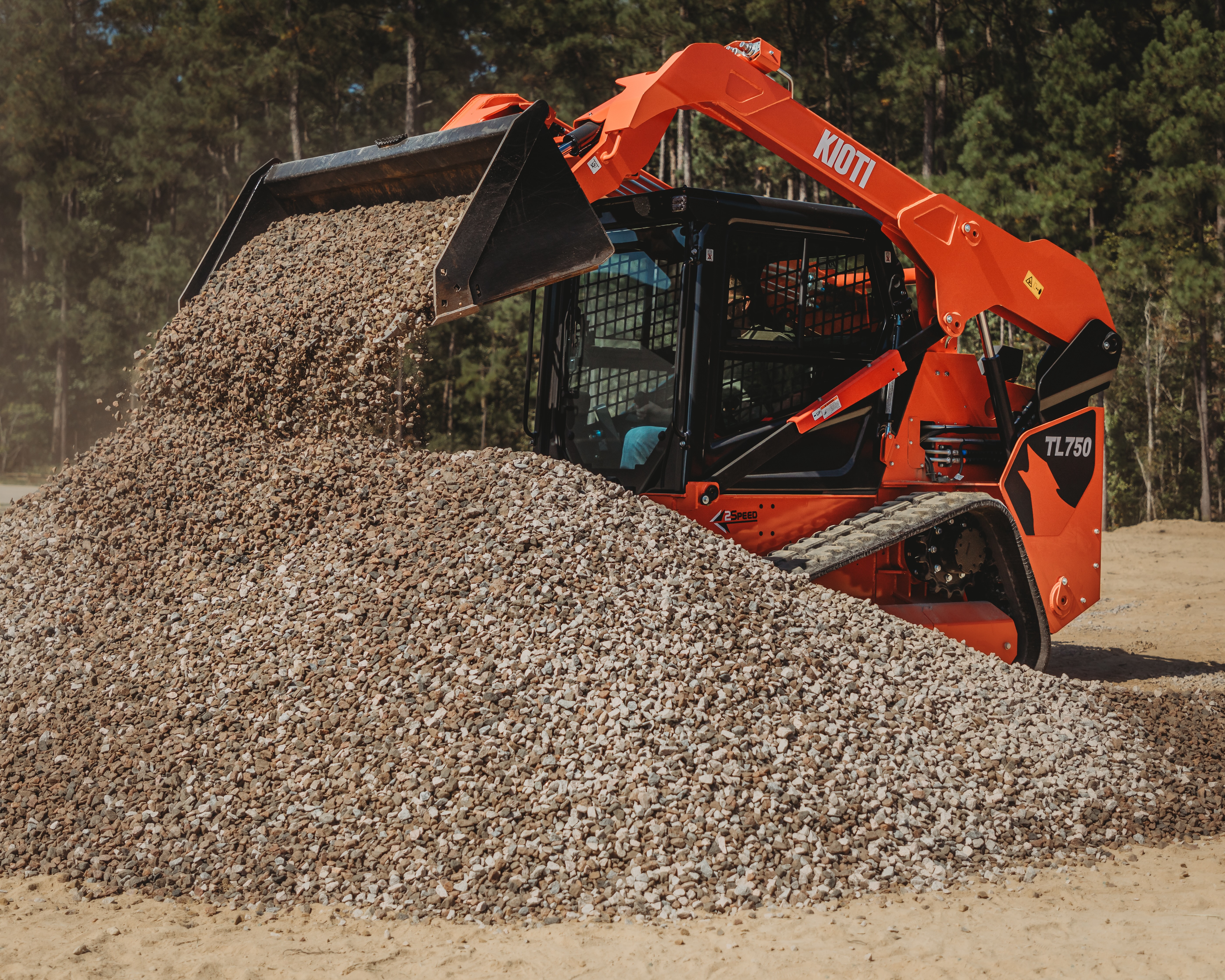Powered by a 74-hp diesel engine, the machine offers two-speed travel, pilot hydraulic joystick controls, rearview camera, sliding overhead door and LED work lights.
