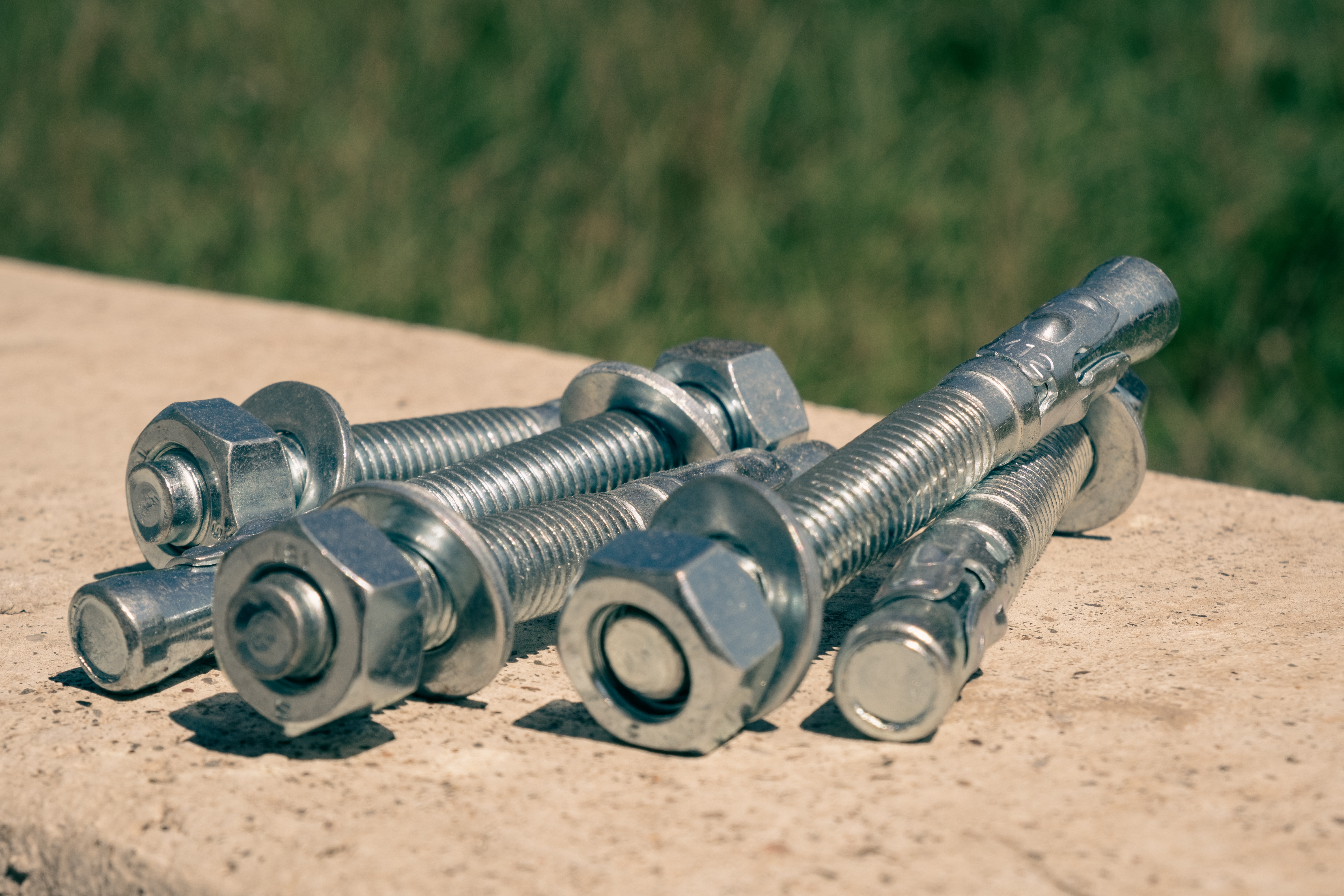 Protecting this protruded area of the wedge anchor is crucial. If an installation tool, such as a hammer, damages the threads then the nut can no longer be put on or taken off.
