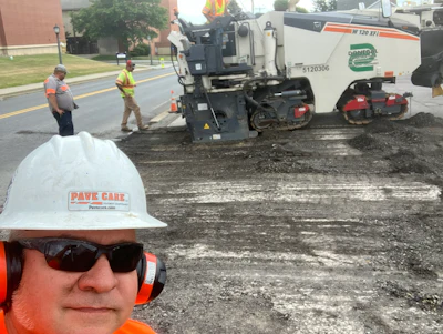Pave Care Founder Rick Dillaman (white hard hat) and Pave Care employee Joe Dillaman (background) oversee a sub-contracted milling crew for a paving project at Clarion University.
