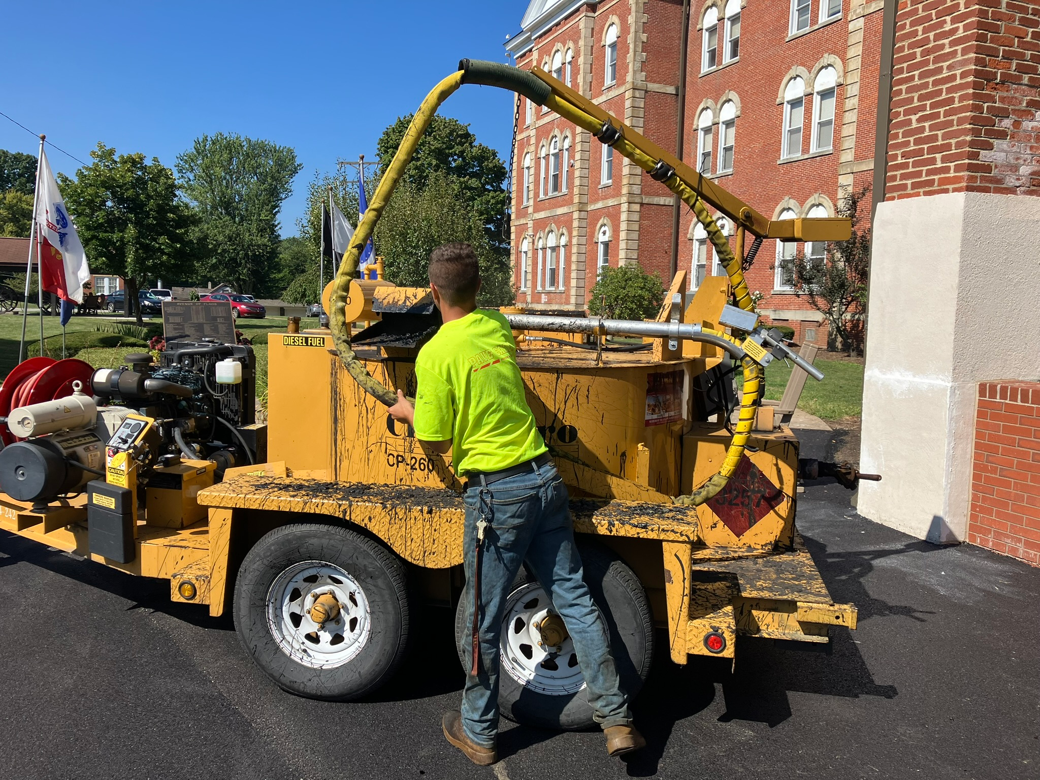 Pave Care employee Christian Shaffer crack sealing for a paving project at Eire Veterans Home.
