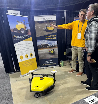 CIVRobotics Business Development Manager Brandon Udelhofen explaining the striping robot to an attendee.