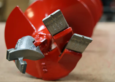 The working tip of an earth drill, auger