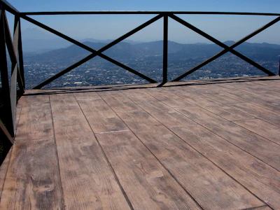 Mountain vista from wooden observation deck with urban landscape and distant peaks