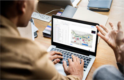 Professional analyzing data visualization on laptop at workplace desk