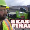Construction worker in safety vest and hard hat near green industrial machinery