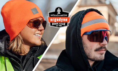 Two workers wearing bright orange Ergodyne winter hats and protective sunglasses