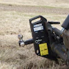Ignite equipment mounting bracket attached to mechanical machinery in grassy field
