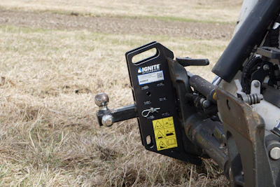 Ignite equipment mounting bracket attached to mechanical machinery in grassy field