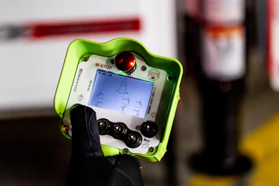 Bright green robotic control panel with digital screen and control buttons