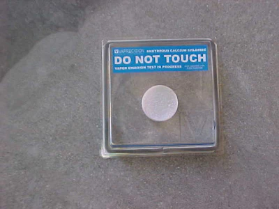 Scientific test kit with 'Do Not Touch' warning label and white circular sample