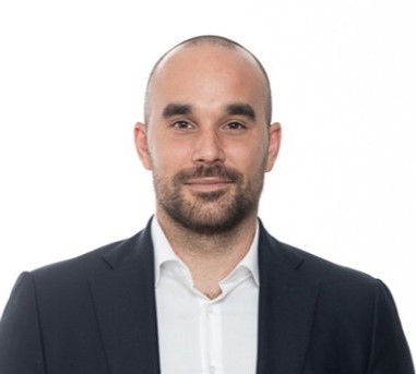Professional bald man in dark suit and white shirt, neutral background Headshot