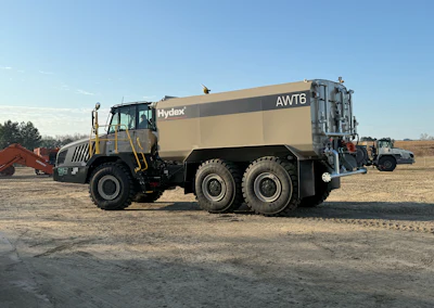 Large tan Hydex AWT6 articulated water truck on dirt construction site