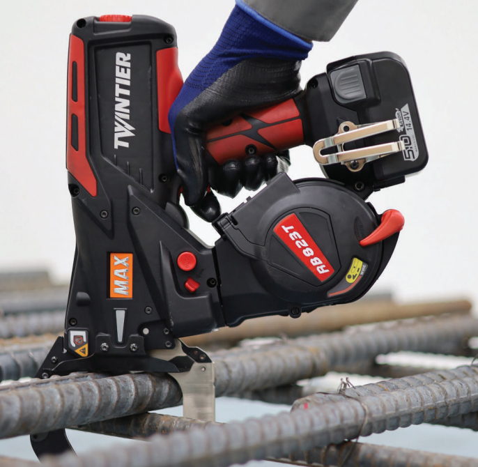 Construction worker using MAX rebar tying tool on steel reinforcement bars