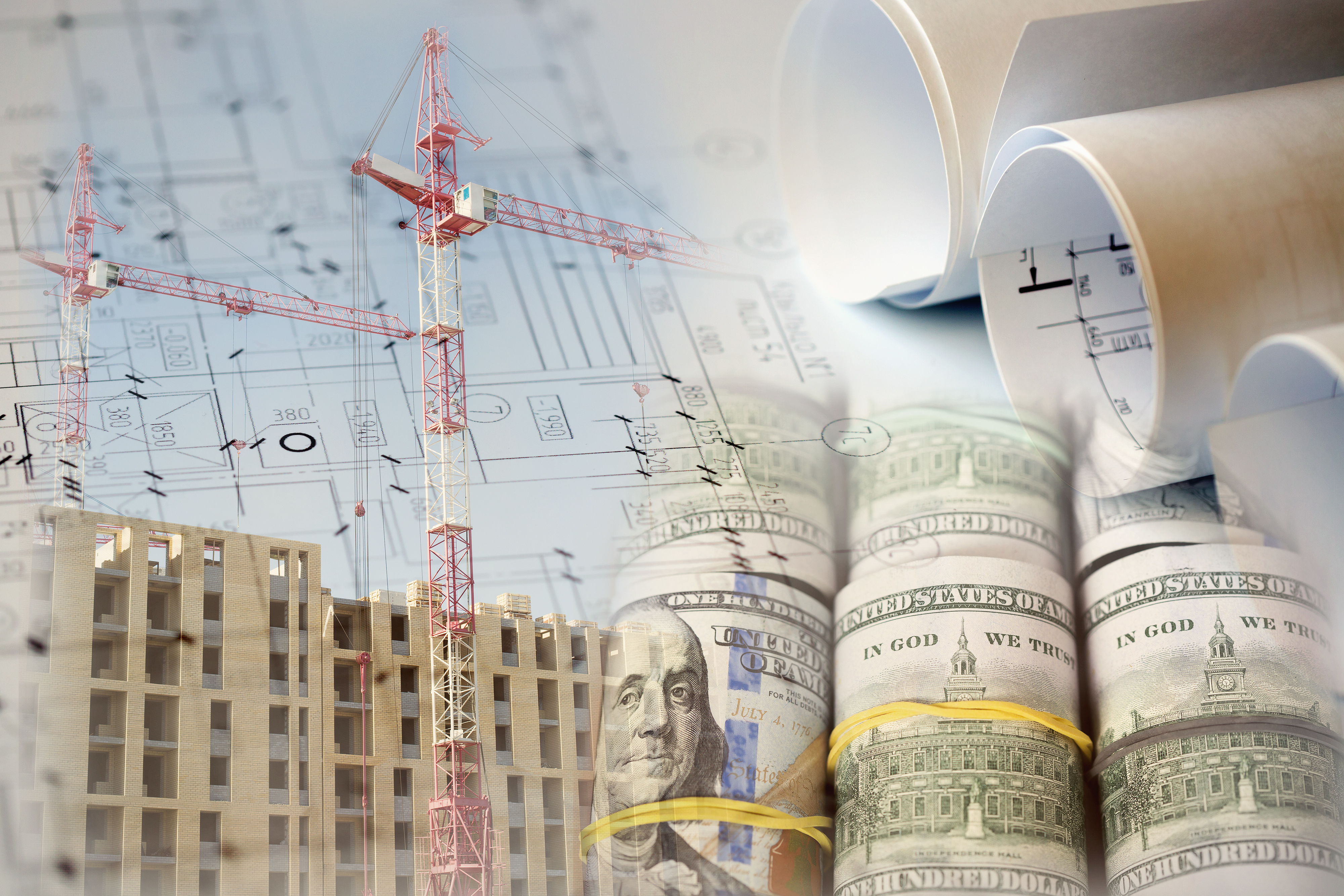 Construction crane and architectural blueprints with US dollar bills
