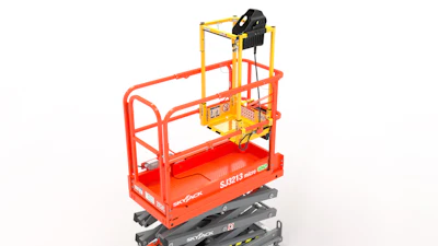 Red SkyJack scissor lift platform elevated on gray mechanical base