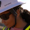 Construction worker wearing white Studson safety helmet and sunglasses