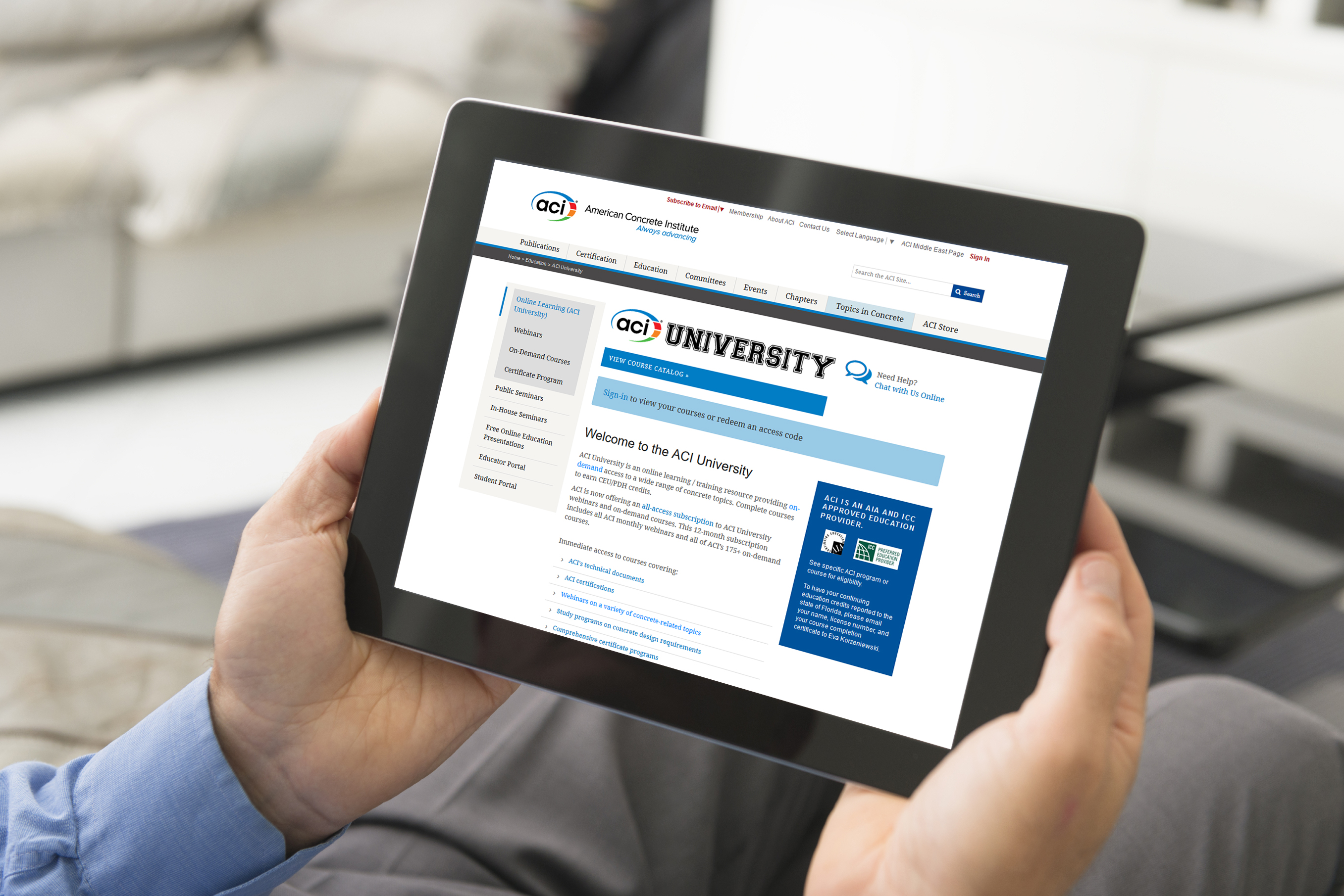 Hands holding tablet displaying ACI University online learning website