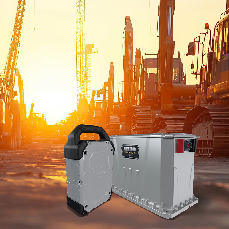 Industrial lithium batteries with construction equipment at sunset