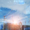 Construction site with digital technology interface, cranes, and building structures