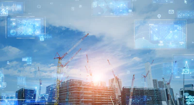 Construction site with digital technology interface, cranes, and building structures