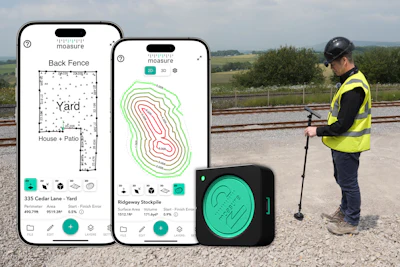 Land surveyor using mobile app and measurement device near railway tracks