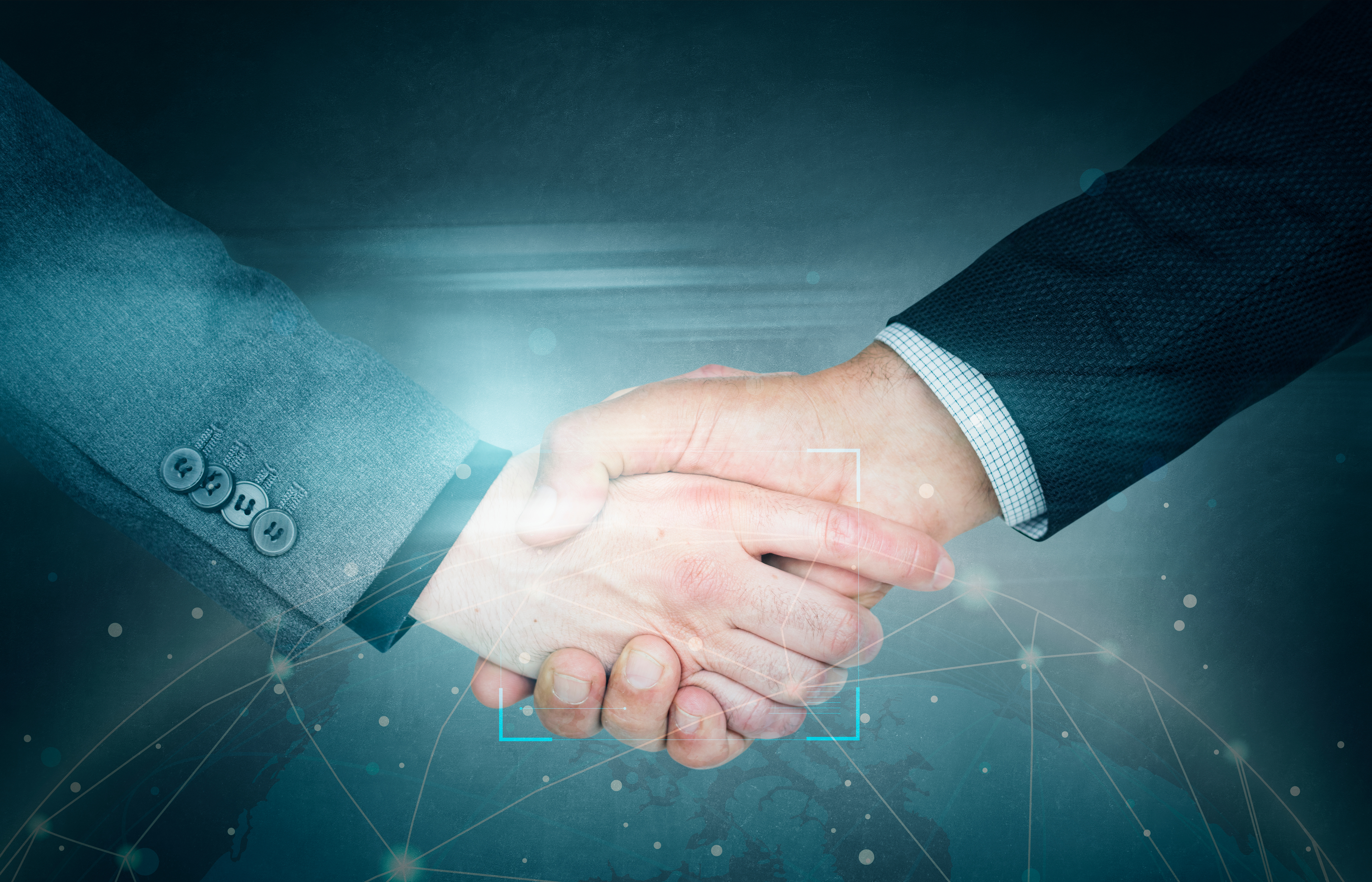 Professional business handshake with digital network connections in background