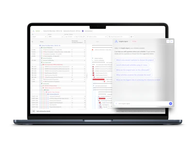 Laptop screen showing analytics dashboard with multiple panels and chat interface