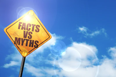 Yellow road sign reading 'Facts vs Myths' against bright blue sky with clouds