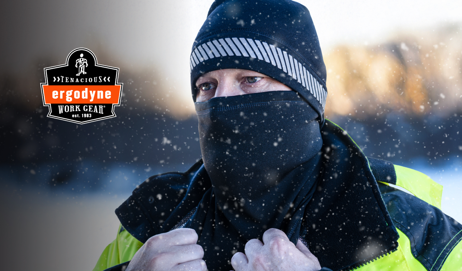 Worker in winter gear wearing black and yellow jacket with Ergodyne logo