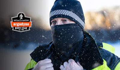 Worker in winter gear wearing black and yellow jacket with Ergodyne logo