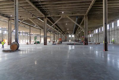 Spacious industrial warehouse interior with concrete floors and structural steel beams