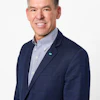 Smiling professional in navy blazer and striped shirt