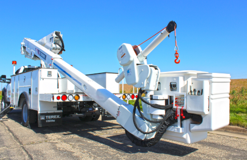 White utility truck with hydraulic crane mounted on industrial work site