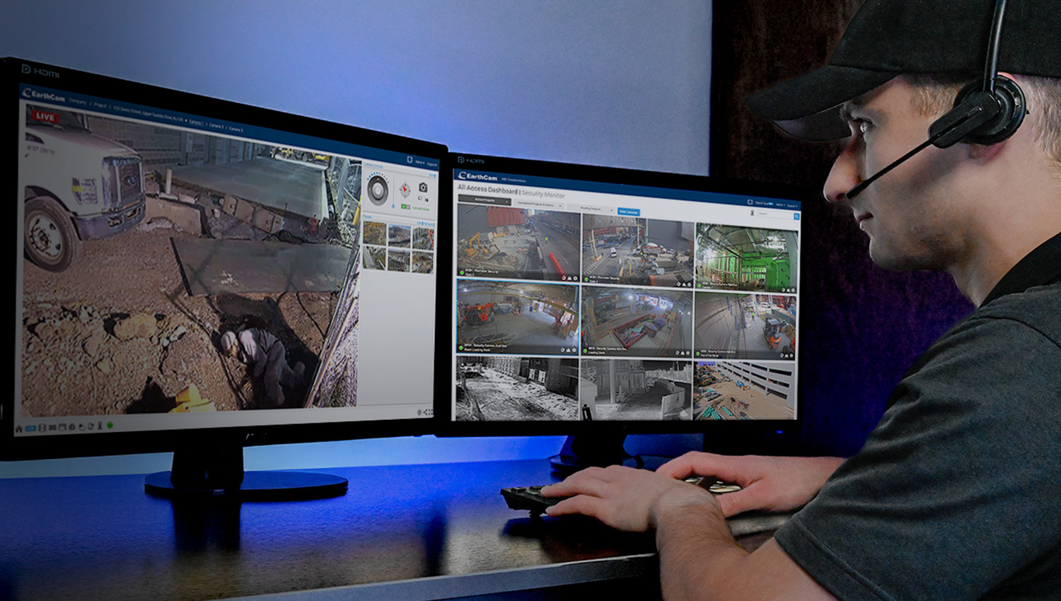 Security professional monitoring multiple surveillance camera feeds on dual computer screens