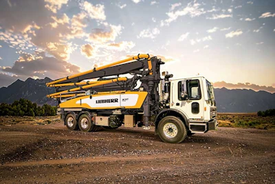 Liebherr concrete pump truck at sunset with mountain landscape